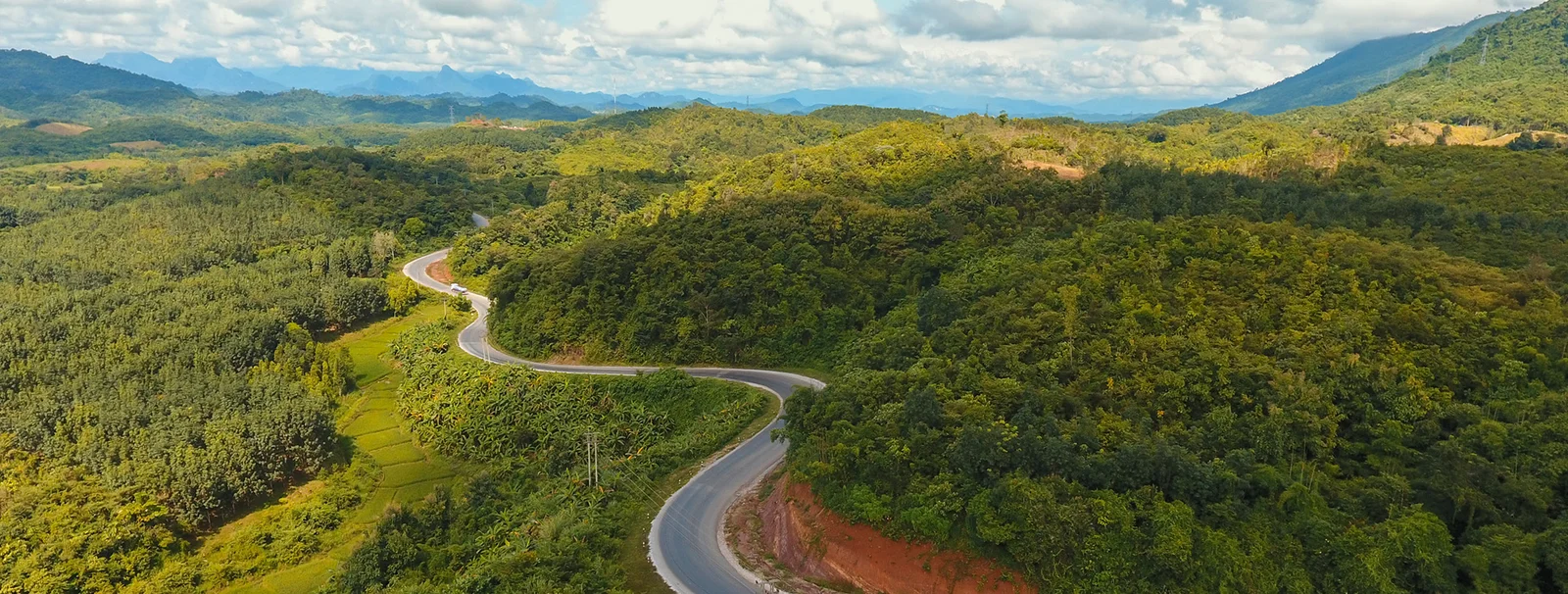 A winding road through the green mountains of Northern Thailand